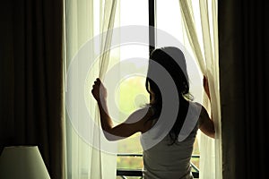 Young woman open window