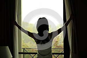 Young woman open window