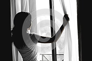 Young woman open window