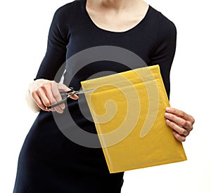 Young woman opening envelope