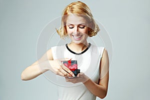 Young woman opening jewelery gift box