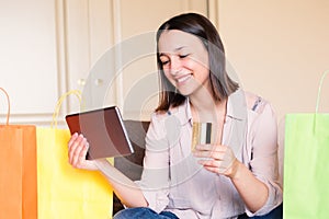 Young woman opening packet at home