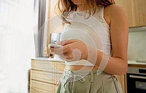 Young woman operates wireless security system in a modern apartment.