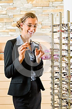 Young woman at optician with glasses