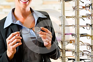 Young woman at optician with glasses