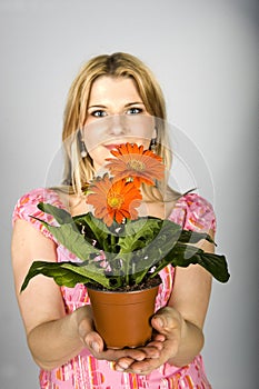 Young woman with orange flowers