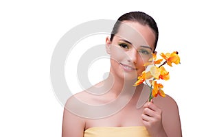 The young woman with orchid flower isolated on white