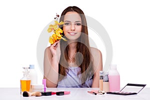 The young woman with orchid flower isolated on white