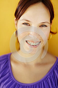 Young woman with orthodontic braces smiling