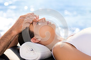 Young woman at osteopathic treatment session outdoors. photo