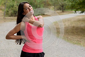 Young woman out jogging suffers a muscle injury