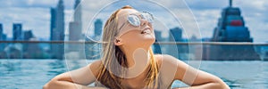 Young woman in outdoor swimming pool with city view in blue sky BANNER, LONG FORMAT