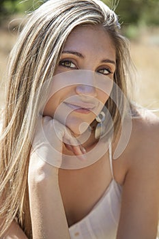 Young woman outdoors portrait. Soft sunny colors.