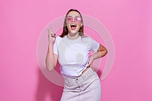 Young woman over isolated pink background with glasses