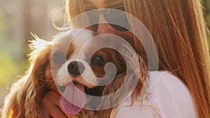 A young woman owner hugs her dog