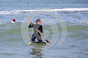 Young woman paddling on a board in Punta Hermosa, Peru photo