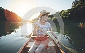 Young woman paddling canoe