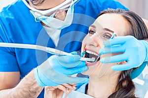 Young woman during painless oral treatment in a modern dental office