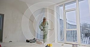 Young Woman Painting Apartment Walls During Renovation