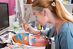 Young Woman Painting Clay Mask