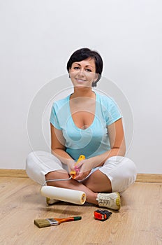 Young woman with painting roller