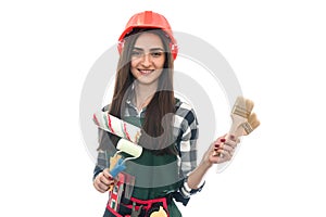 Young woman with painting tools isolated on white