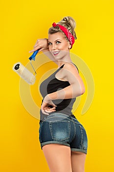 Young woman painting wall