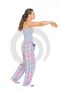 Young woman in pajamas sleep walking