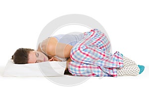 Young woman in pajamas sleeping on pillow