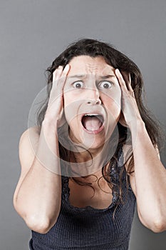 Young woman panicking expressing jaw dropping surprise