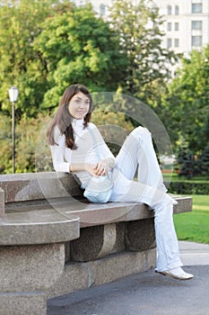 Young woman in a park looking sideway photo