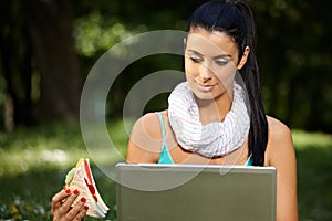 Young woman in park at lunchtime