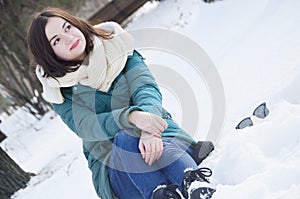 A young woman in the park in winter