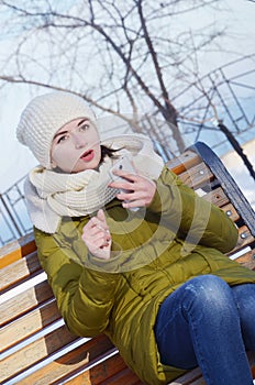 A young woman in the park in winter