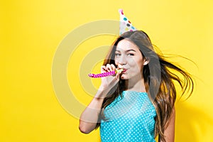 Young woman with party hat with noisemaker