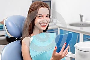 Young woman patient visiting dentist in the dental
