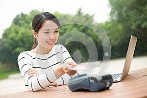 Young Woman pay on pos terminal with credit card