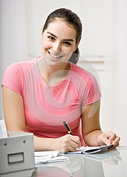 Young woman paying bills