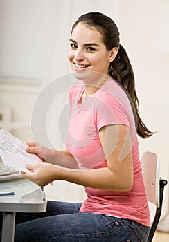 Young woman paying bills