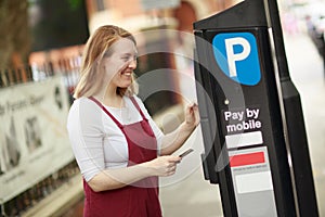 Young woman paying a parking fee