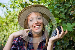 Young woman peasant grape sign good with hand