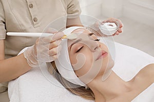 Young woman during peeling procedure in salon