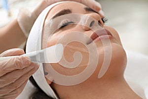 Young woman during peeling procedure in salon, closeup