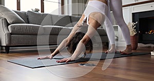 Young woman perform yoga asanas at home