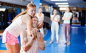 Young woman performing chokehold