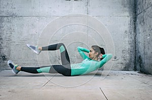 Young woman performing core crunch exercise