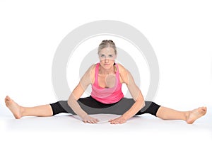 Young woman performing a straddle split stretch photo