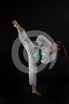 Young Woman Performing Tae Kwon Do High Kick