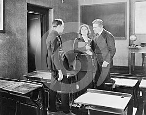 Young woman performing for two men in a class room