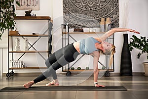 Young woman performing wild thing yoga pose on mat